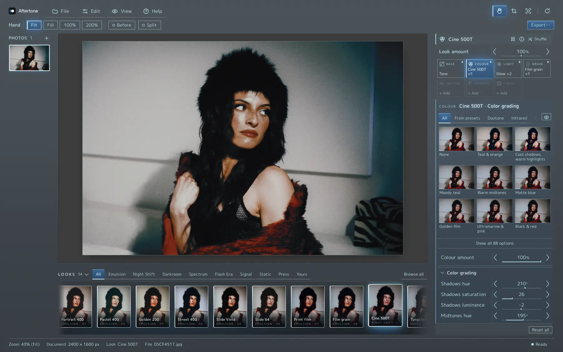 Aftertone with the Cine 500T look: the look strip under the photo, the Look amount slider and the recipe card with Base, Colour, Light and Grain, on a portrait of a woman in a fur hat